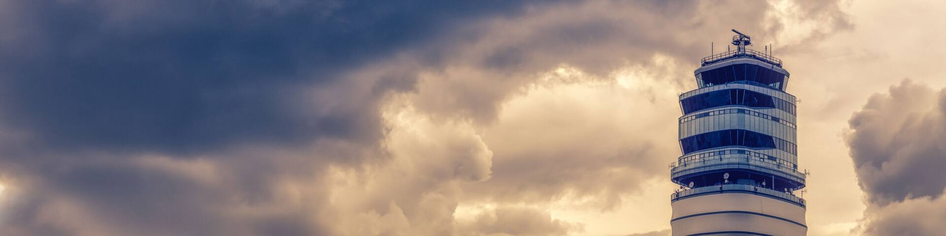 Airport traffic control tower at vienna International Airport on a dark cloud. Austria.