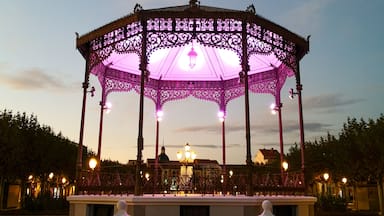 A gazebo with intricate lattice work and a central lantern, surrounded by a paved plaza.
