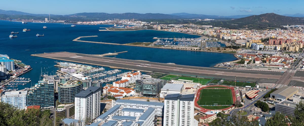 A coastal city with a marina, airport, and residential buildings.