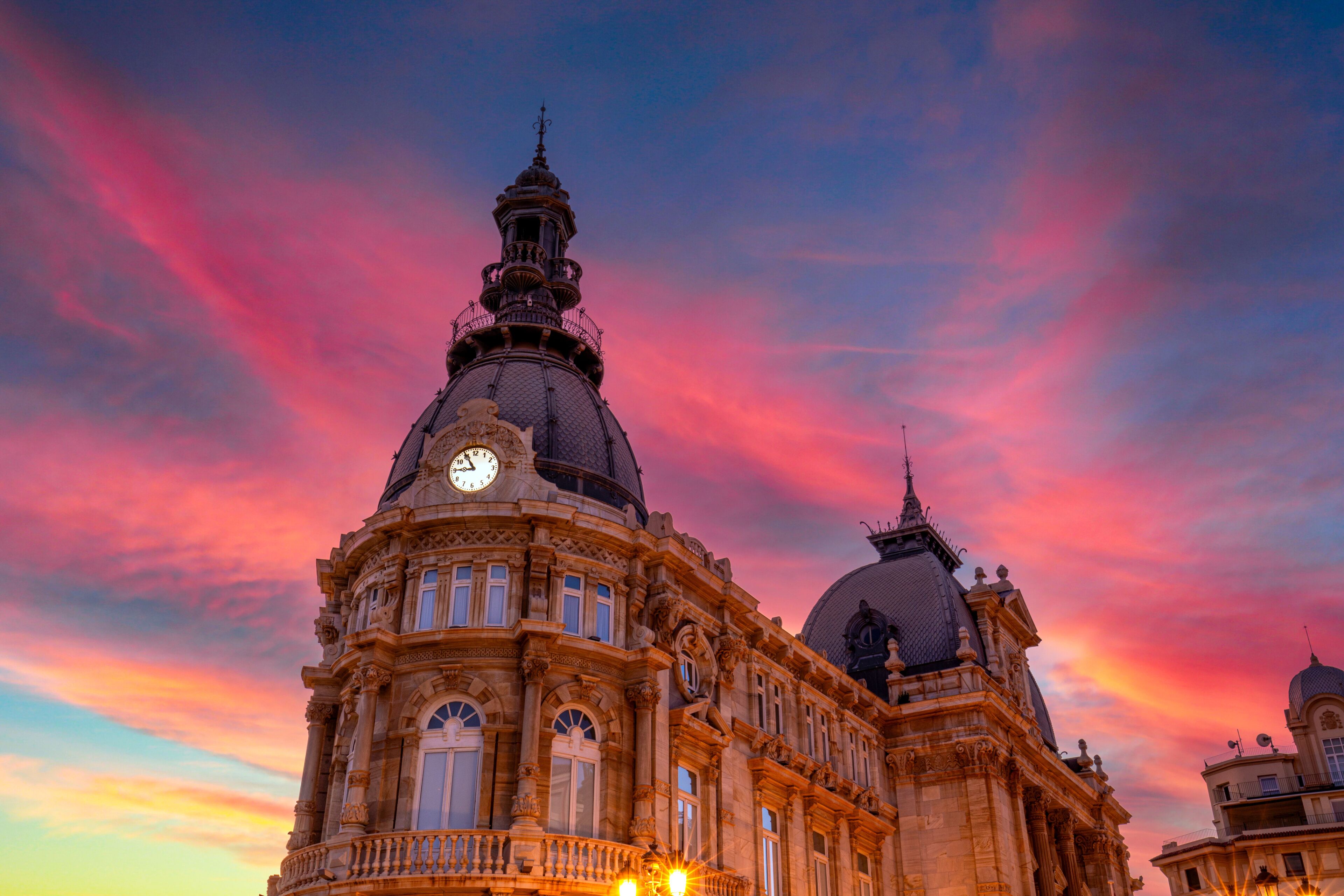 Detail of the Town Hall of Cartagena, Region of Murcia, Spain, with a stunning pink sky at sunset