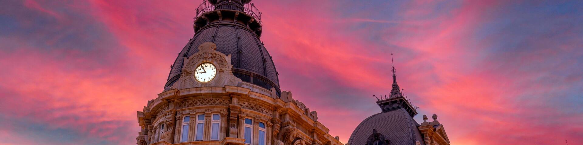 Detail of the Town Hall of Cartagena, Region of Murcia, Spain, with a stunning pink sky at sunset