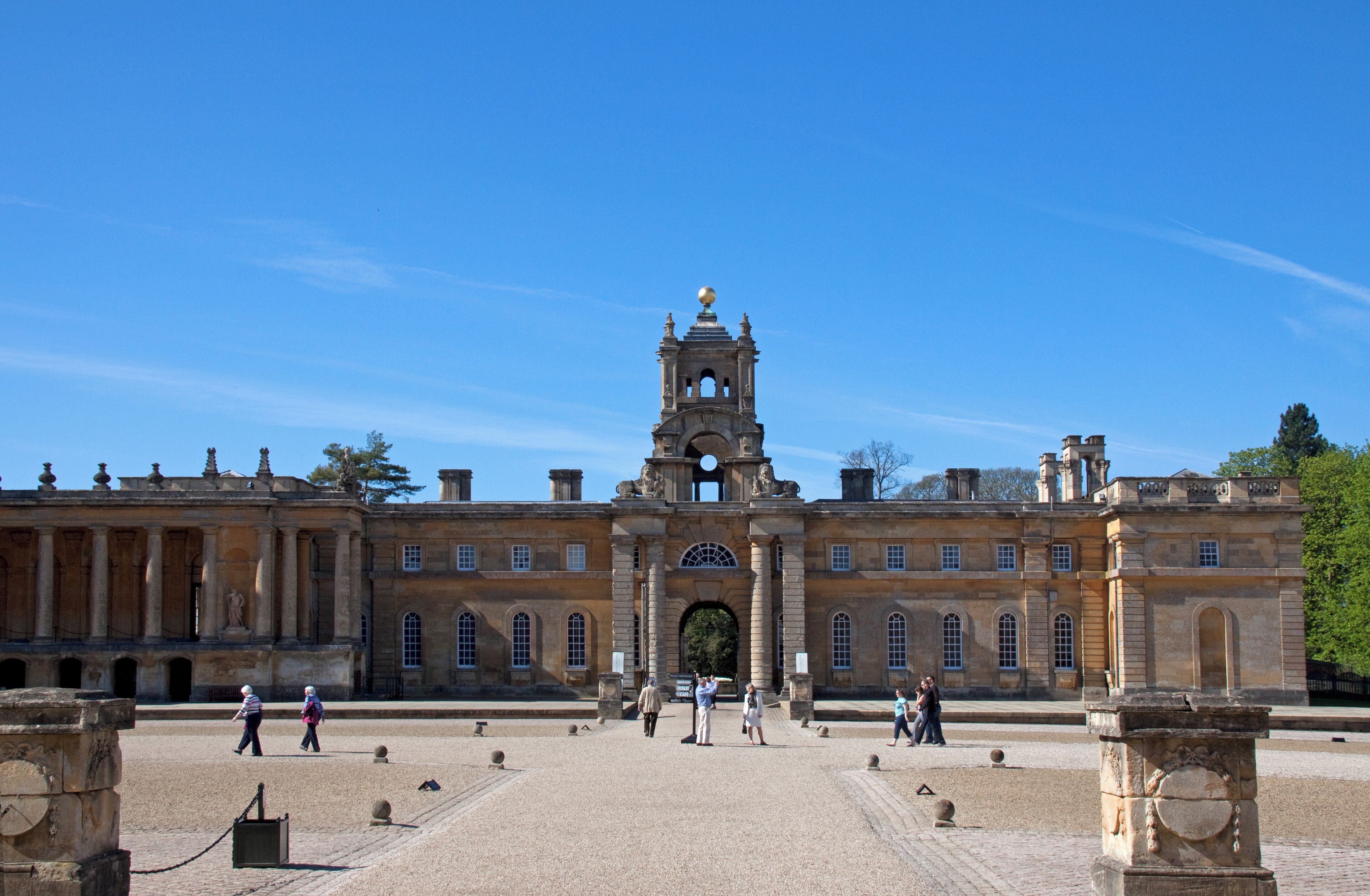 A historic building with a central archway and a bell tower.