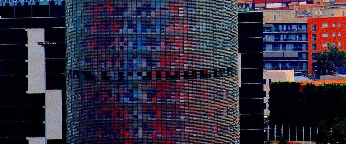 #BVSBlue
Taken from Sagrada Familia, The Torre Glòries, formerly known as Torre Agbar, is a 38-story skyscraper/tower located between Avinguda Diagonal and Carrer Badajoz, near Plaça de les Glòries Catalanes, which marks the gateway to the new technological district of Barcelona, Catalonia, Spain. It was designed by French architect Jean Nouvel in association with the Spanish firm Fermín Vázquez Arquitectos and built by Dragados. The Torre Glòries is located in the Poblenou neighbourhood of Barcelona and it was originally named after its owners, the Agbar Group, a holding company whose interests include the Barcelona water company Aigües de Barcelona. In 2017 it was purchased by Merlin Properties real estate group and it was renamed as Torre Glòries after the name of the adjacent square.