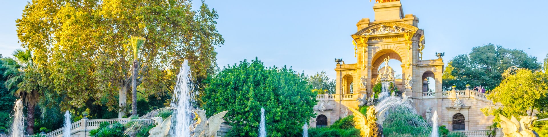 A fountain, a bridge, and a historic building with statues.