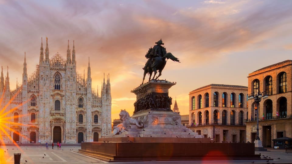 A grand cathedral with intricate Gothic architecture, a statue of a historical figure, and a bustling square with people and pigeons.