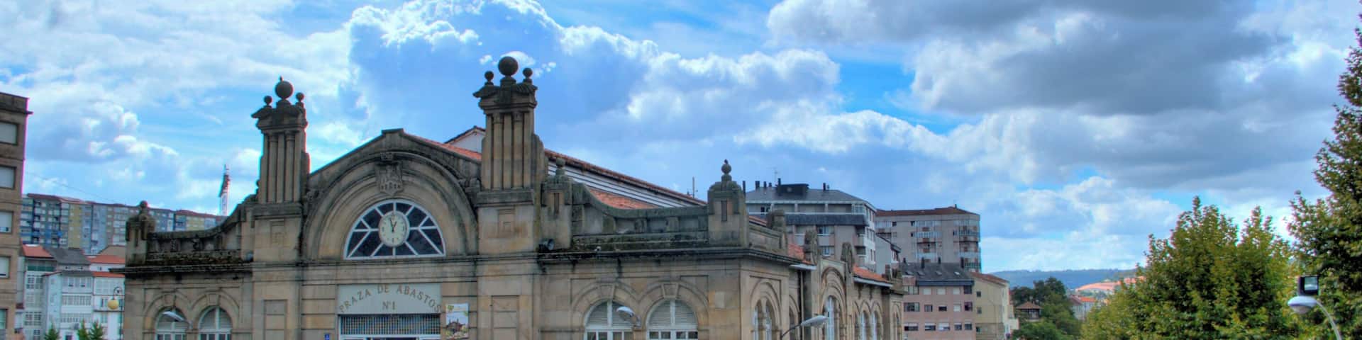 A historic building with a clock tower and a staircase leading to the entrance.