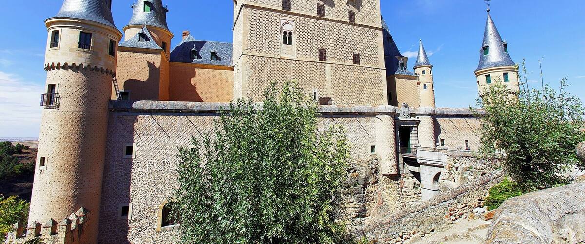 Segovia's castle sits like the bow of a ship at the northwest tip of the city. It's a massive, imposing structure that was added to over many generations. Pictured here is the side of the castle facing the city. The tall, awkward-looking tower in the middle was added by King John II in the early 15th century.
The true beauty of the castle, though, lies with it's interior rooms, which were handcrafted by Arabian workmen (under Christian rule) in the early 14th-century. The attention to detail and the scale of the works rival those found at the Alhambra and the Alcázar of Seville. Well worth the entry fee just to wander the rooms.