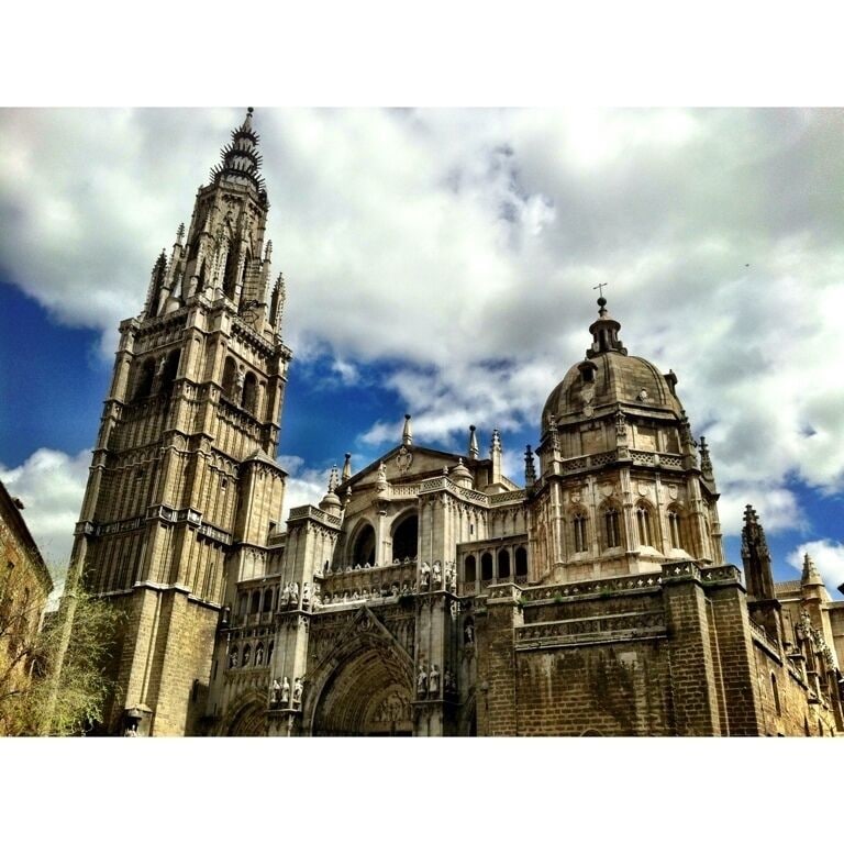 A Gothic cathedral with a tall spire and a large dome.