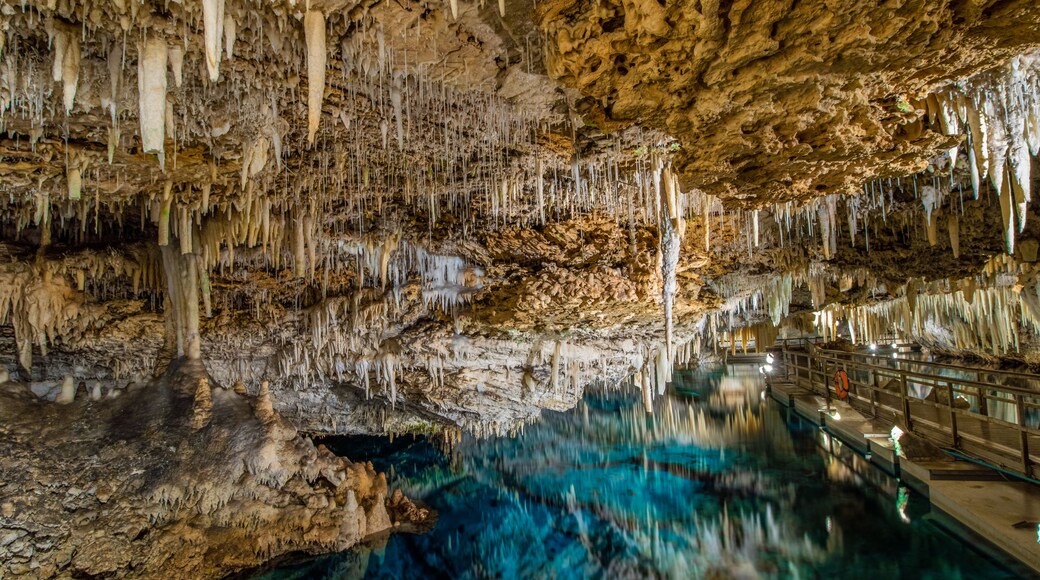 Stalactites and stalagmites surrounded by crystal clear turquoise waters within the Fantasy and Crystal caves. Hamilton Parish, Bermuda.