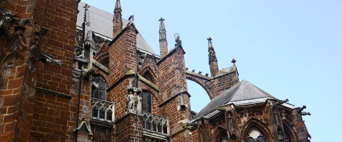 A Gothic-style church with intricate brickwork and pointed arches.