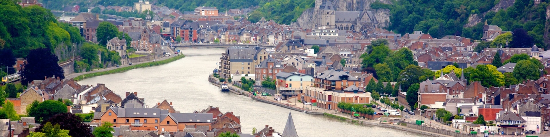 Belgian Ardennes which includes a small town or village and a river or creek