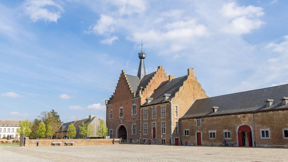 A historic building with a prominent tower and arched windows.