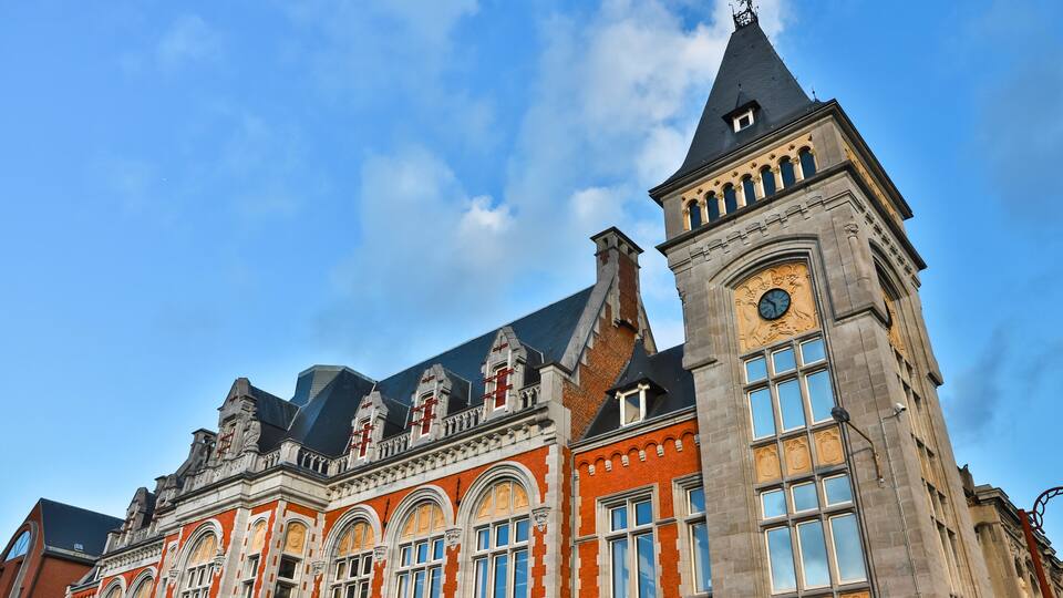 A historic building with ornate architecture, including a clock tower and arched windows.