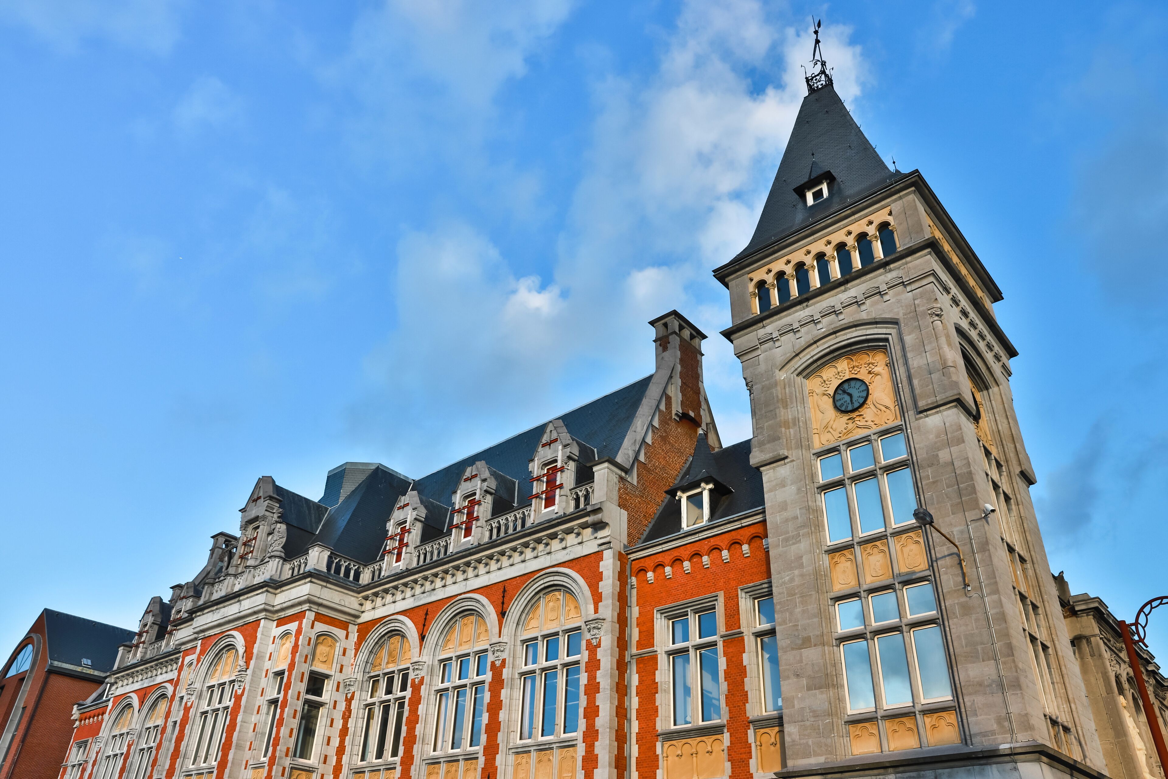 A historic building with ornate architecture, including a clock tower and arched windows.