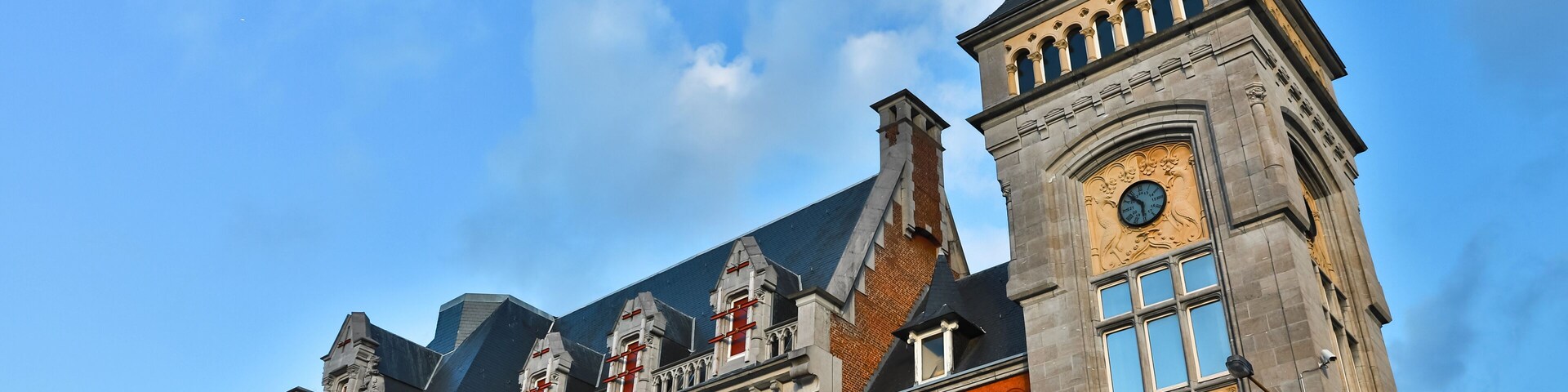 A historic building with ornate architecture, including a clock tower and arched windows.