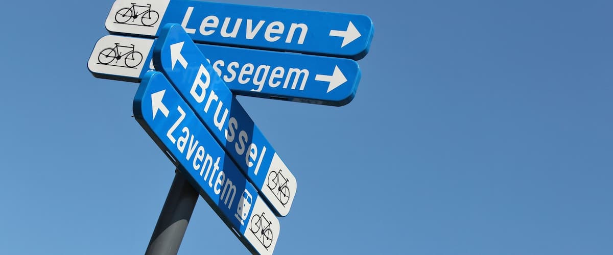 A directional sign with arrows pointing to Leuven, Bruxelles, and Zaventem.