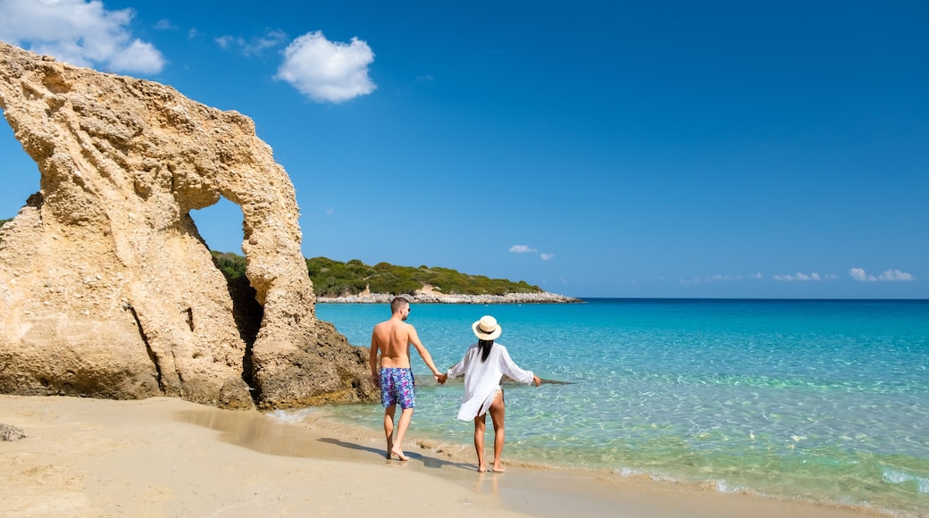 Voulisma Beach Istron Crete Greece, the most beautiful beaches of Crete island Istron Bay near Agios Nikolaos. A young couple on vacation in Greece Crete during the summer holidays
