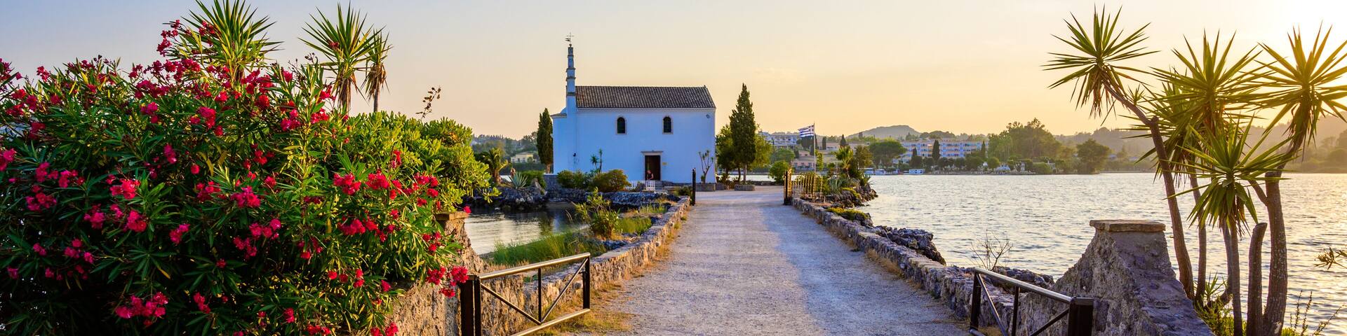 Ypapanti Church - Beautiful scenery at sunset in Gouvia Bay – small ancient white church on a pier, Corfu island, Ionian sea, Greece, Europe