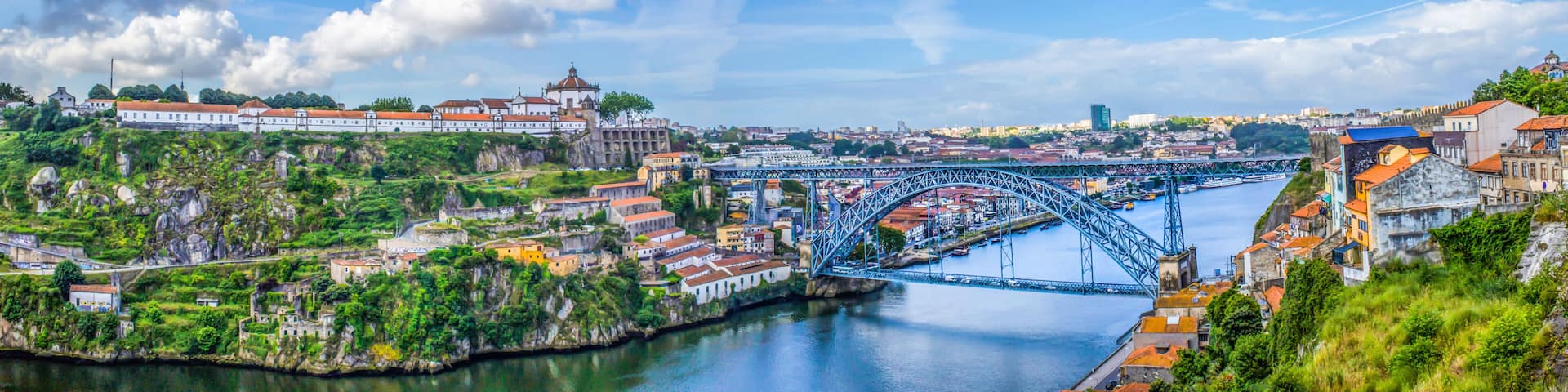 View of the historic city of Porto, Portugal with the Dom Luis bridge and blue sky / Panoramic view from the city of Porto in Portugal / Ancient city Porto,metallic Dom Luis bridge.