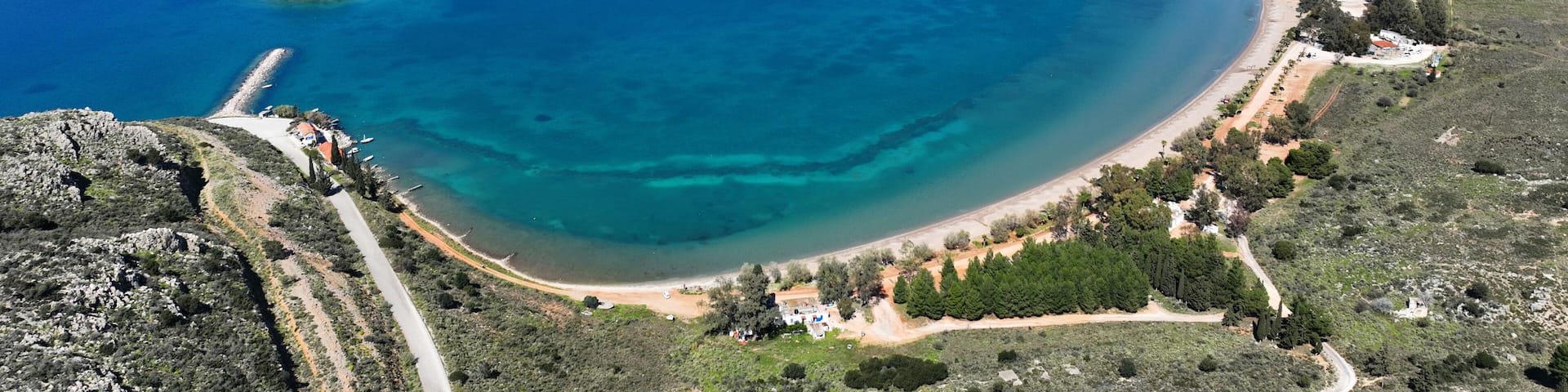 Aerial drone photo of paradise scenic round sandy beach of Karathonas next to historic city of Nafplio, Argolida, Greece
