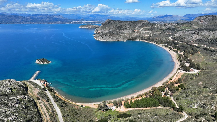 Aerial drone photo of paradise scenic round sandy beach of Karathonas next to historic city of Nafplio, Argolida, Greece