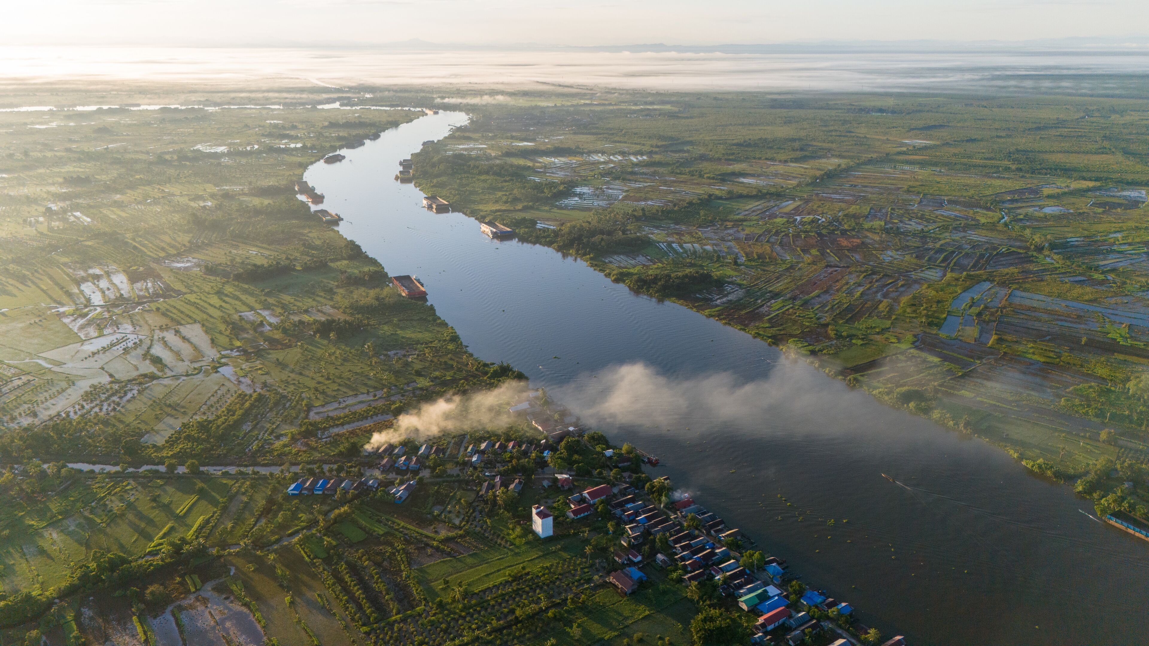 View of a residential village on the riverbank of South Kalimantan from a drone during the day