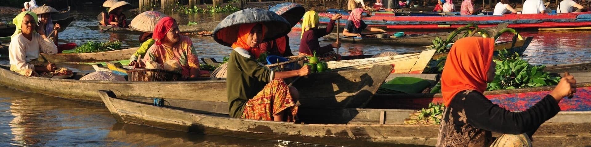A boat ride around the colorful floating markets of Borneo. #Adventure