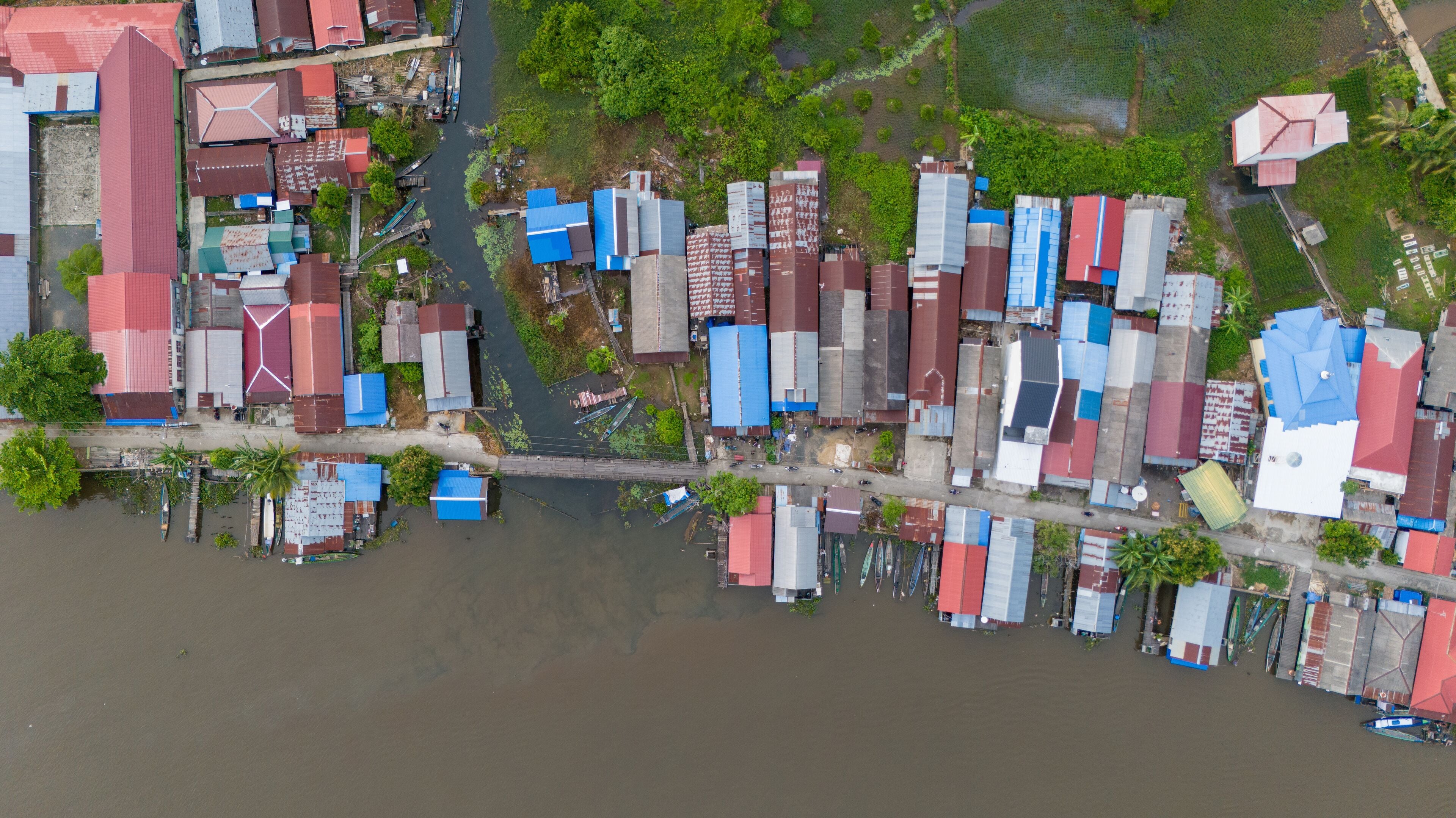 View of a residential village on the riverbank of South Kalimantan from a drone during the day