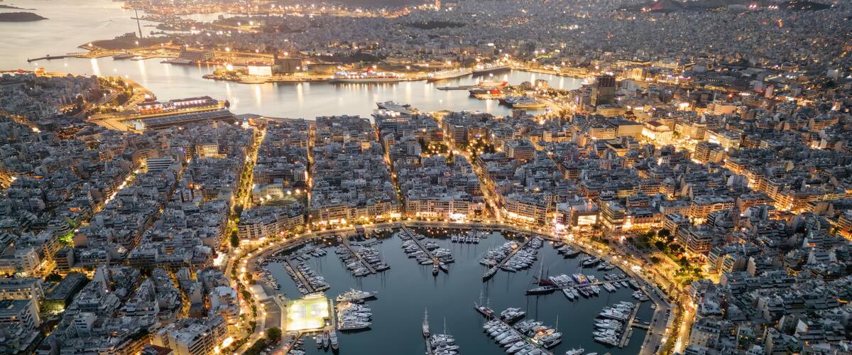 Aerial view of the illuminated Zea Marina in Piraeus, Athens, Greece, with lined up sailing boats and yachts during evening