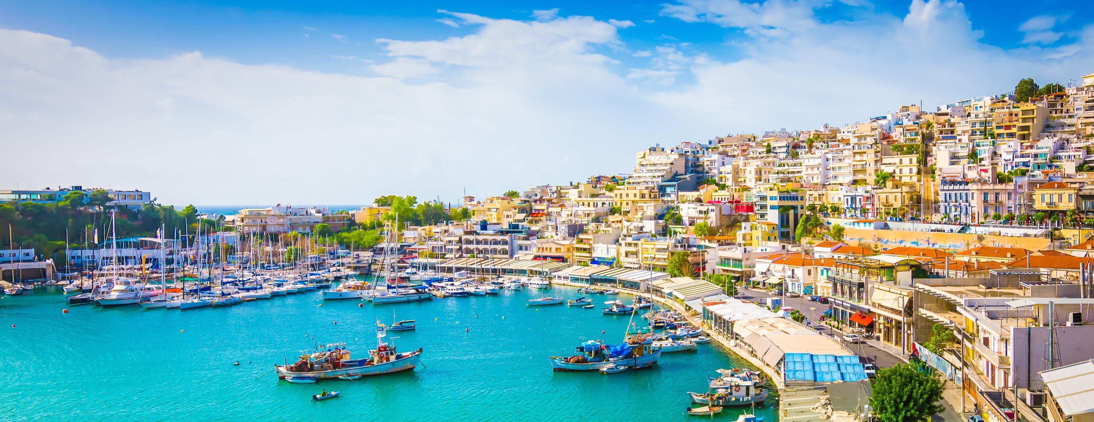 Panoramic view of Mikrolimano with colorful houses along the marina in Piraeus, Greece.