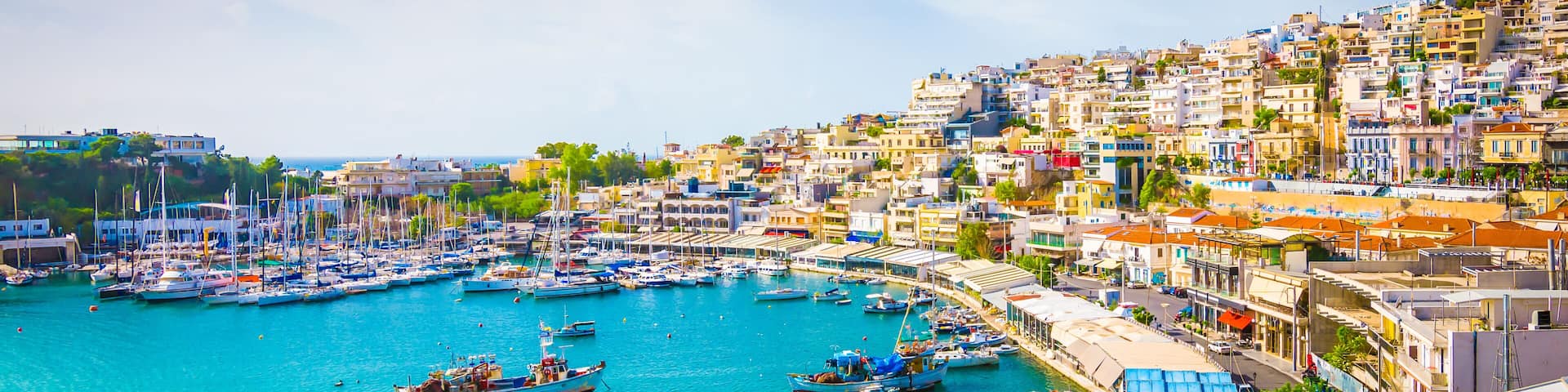 Panoramic view of Mikrolimano with colorful houses along the marina in Piraeus, Greece.