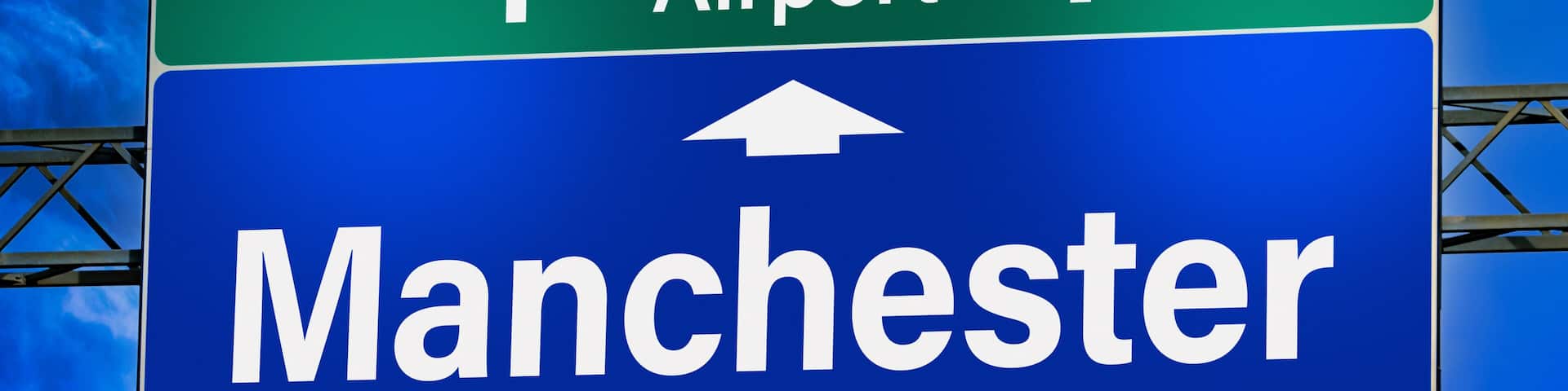 Road sign indicating direction to the city of Manchester