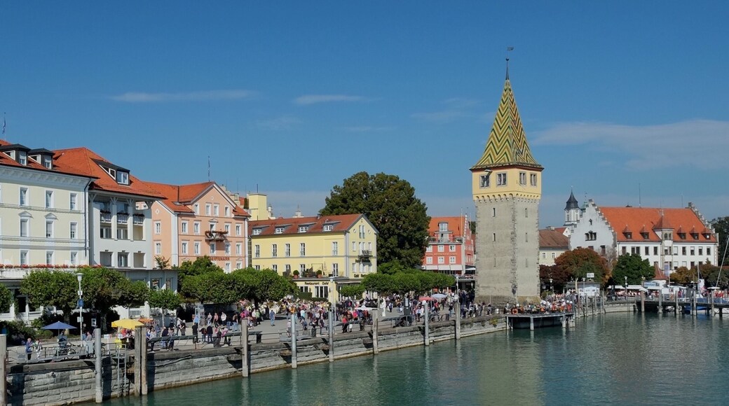 Lindau is a town on Lake Constance or Bodensee in Bavaria, Germany, known for its old town on Lindau island. The harbor has a Bavarian Lion statue and a stone lighthouse with lake and mountain views. On the harborfront Seepromenade, the 12th-century Mangturm is a former watchtower with a pointed, tiled roof. Near restaurant-lined Maximilianstrasse, the Gothic Altes Rathaus (Old Town Hall) has a painted facade.