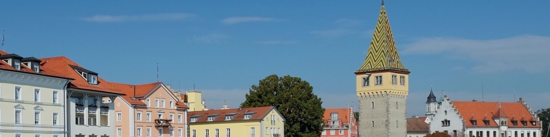 Lindau is a town on Lake Constance or Bodensee in Bavaria, Germany, known for its old town on Lindau island. The harbor has a Bavarian Lion statue and a stone lighthouse with lake and mountain views. On the harborfront Seepromenade, the 12th-century Mangturm is a former watchtower with a pointed, tiled roof. Near restaurant-lined Maximilianstrasse, the Gothic Altes Rathaus (Old Town Hall) has a painted facade.