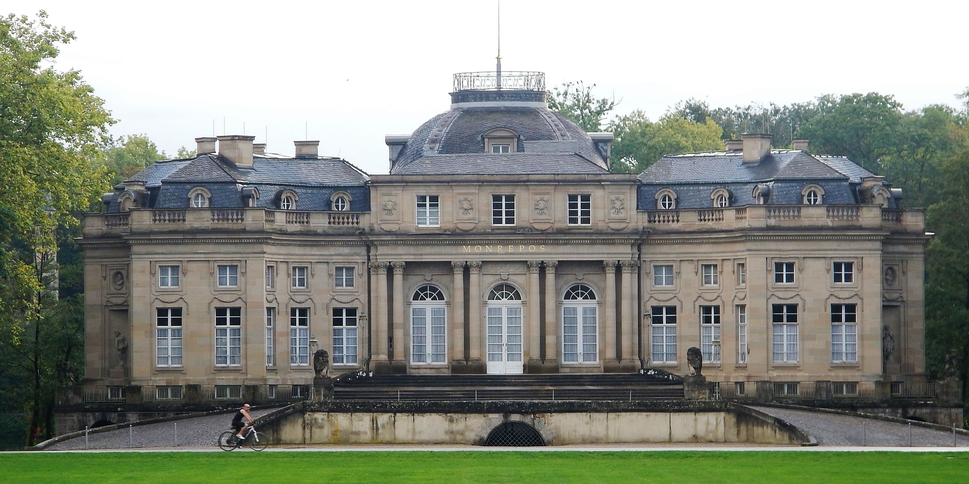 A large, historic building with a central dome and symmetrical windows.