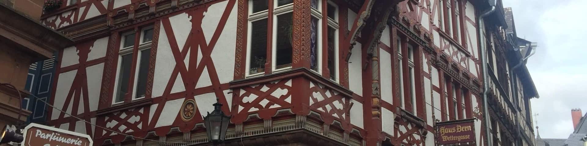 A traditional half-timbered building with a distinctive tower and a sign reading "HUSSEL."