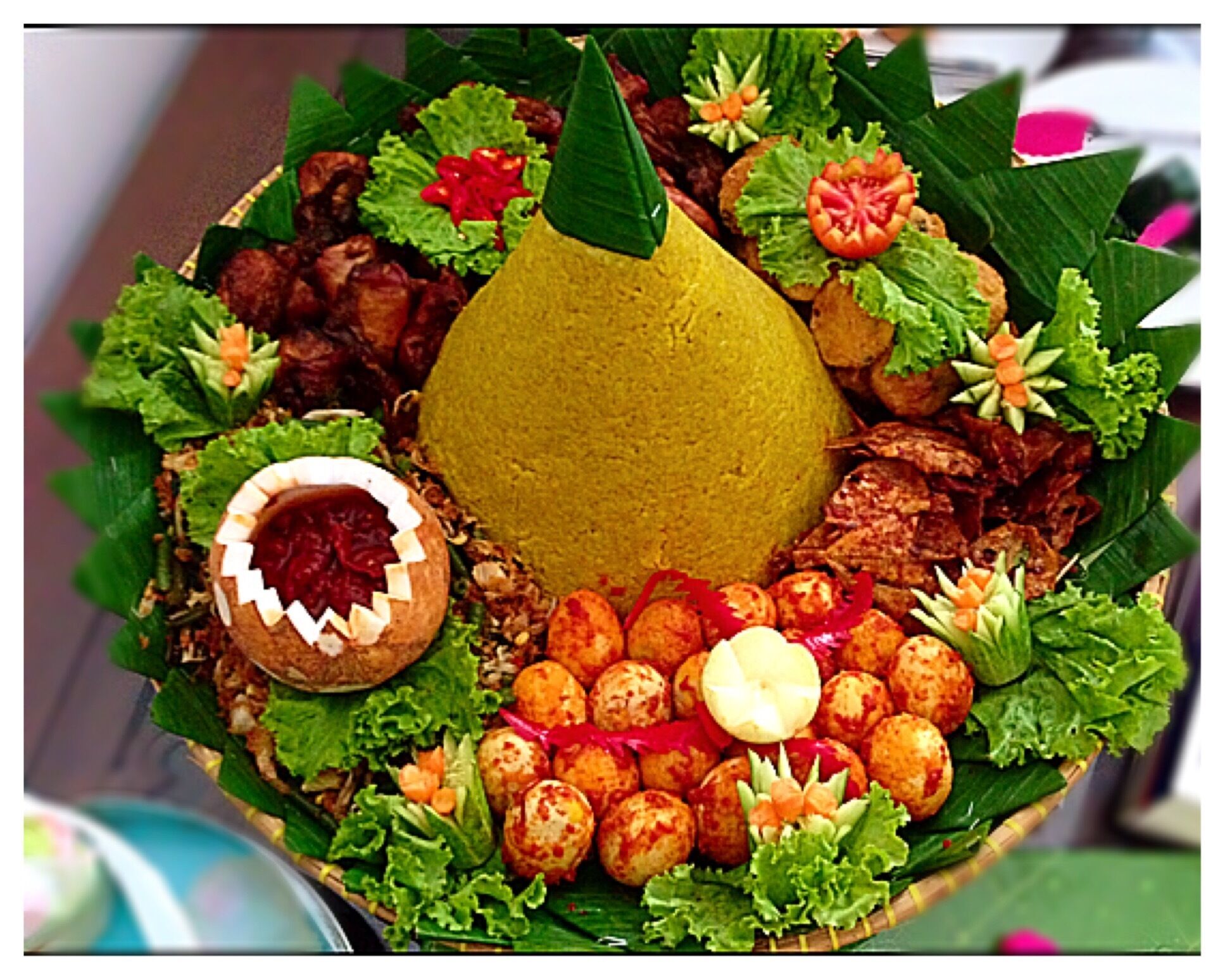 Tumpeng is a cone-shaped rice dish like mountain with its side dishes (vegetables and meat). Traditionally featured in the ceremony, the cone shape of rice is made by using cone-shaped woven bamboo container. It's the National dish of Indonesia. 🚩