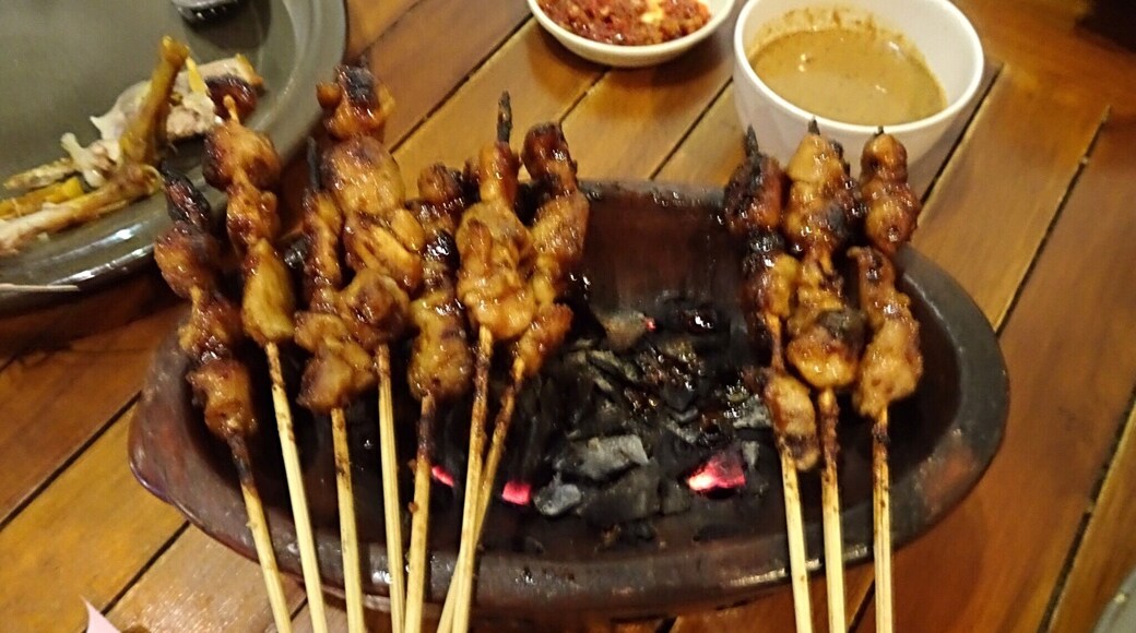 Barbecued meat or Satay is served over burning charcoal here in Bandung.