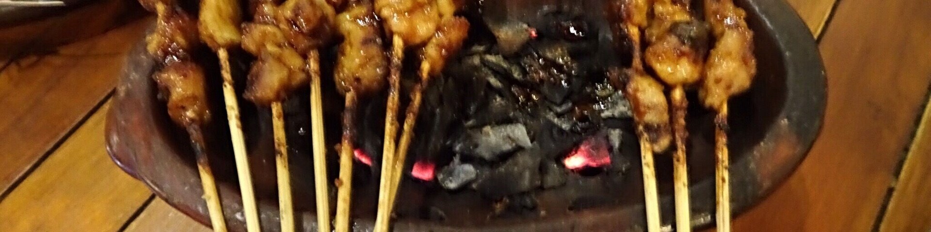 Barbecued meat or Satay is served over burning charcoal here in Bandung.