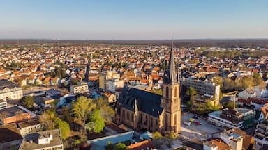 A town with a prominent church steeple and dense residential buildings.