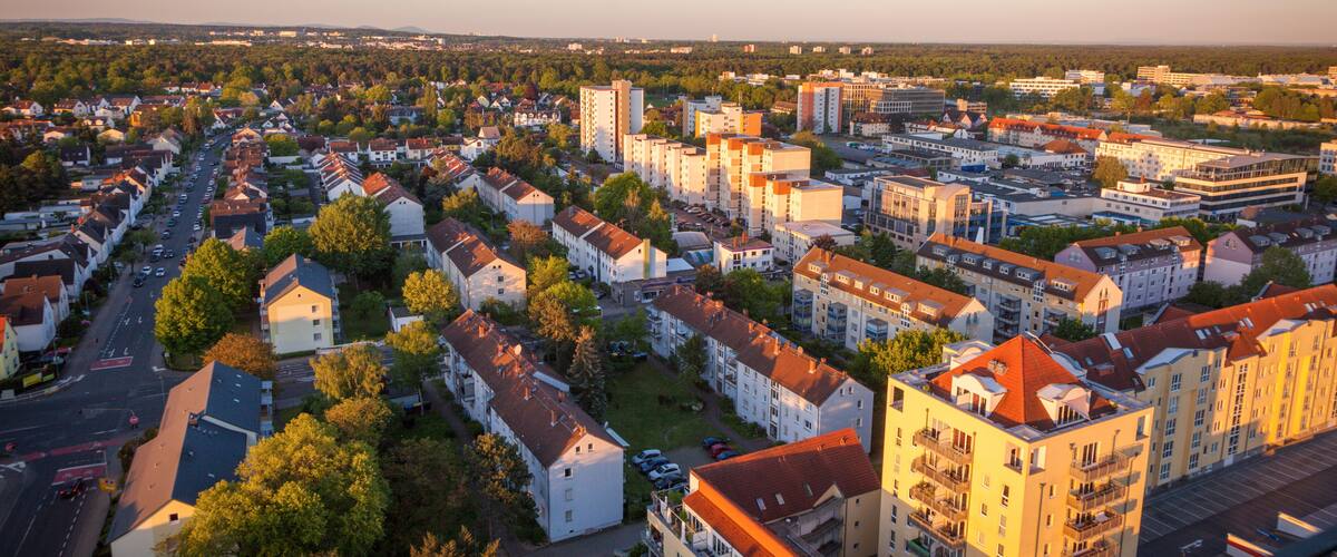A residential area with apartment buildings, streets, and trees.
