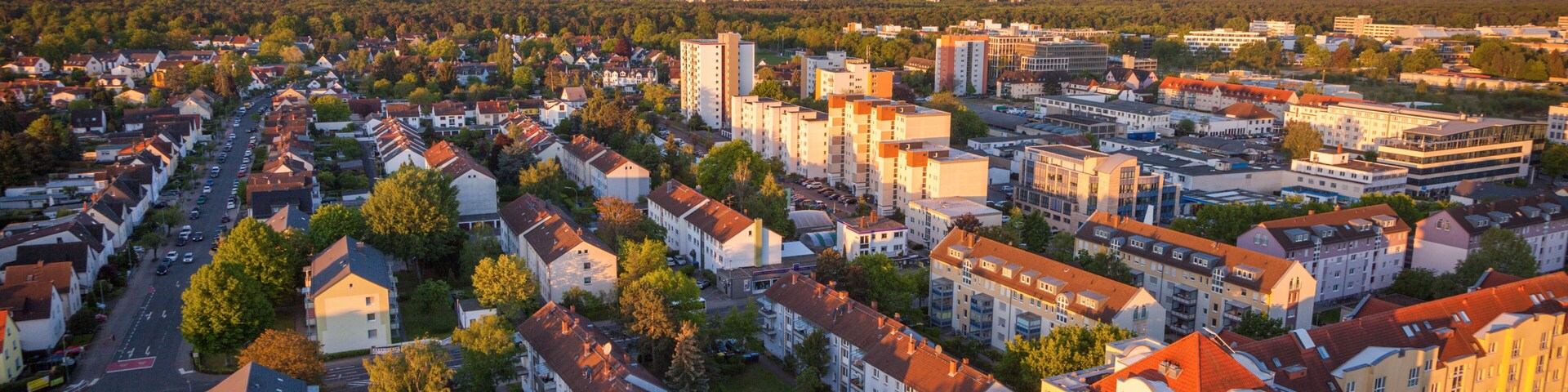 A residential area with apartment buildings, streets, and trees.