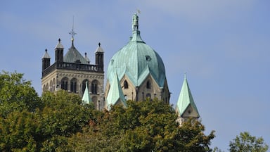 Une église historique dotée d’un grand dôme et de nombreuses flèches, entourée d’une végétation luxuriante.