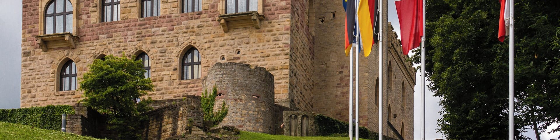 Designation: Monument zone Hambach Castle (also Maxburg) Location: At the top of a wooded foothill on the Haardtrand, southwest of the village on the Schlossberg. Place: Quarter Hambach, Neustadt an der Weinstraße, Rhineland-Palatinate, Germany Construction time: Founded probably in the first half of the 11th century. Description: From 1100 to the early 19th century owned by the cathedral chapter of Speyer, expanded several times, especially in the 13th century. Multiple restored, slighting 1688, under Crown Prince Maximilian 1845-46 neo-Gothic extension by August von Voit. Reinstatement 1955-57 and 1965-69. 1979-82 thorough restoration and complete interior design (architects H. Augeneder, Bad Dürkheim and H. Römer, Kaiserslautern). Restoration of the outer circular wall 1994 to 2000, conversion from 2006 onwards. Remains of a post-Carolingian Ottonian wall (9th / 10th. Century). Partially developed ruin of the "Kestenburg", remains of the donjon, probably about 1200, high facing, four-storey Palas of the 13th century, outer ring wall. Small residuals of the neo-Gothic castle.