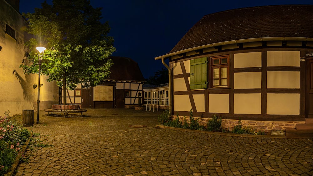 View of the courtyard of the historical museum of the city of Walldorf in hesse with surrounding half-timbered houses during the sunset