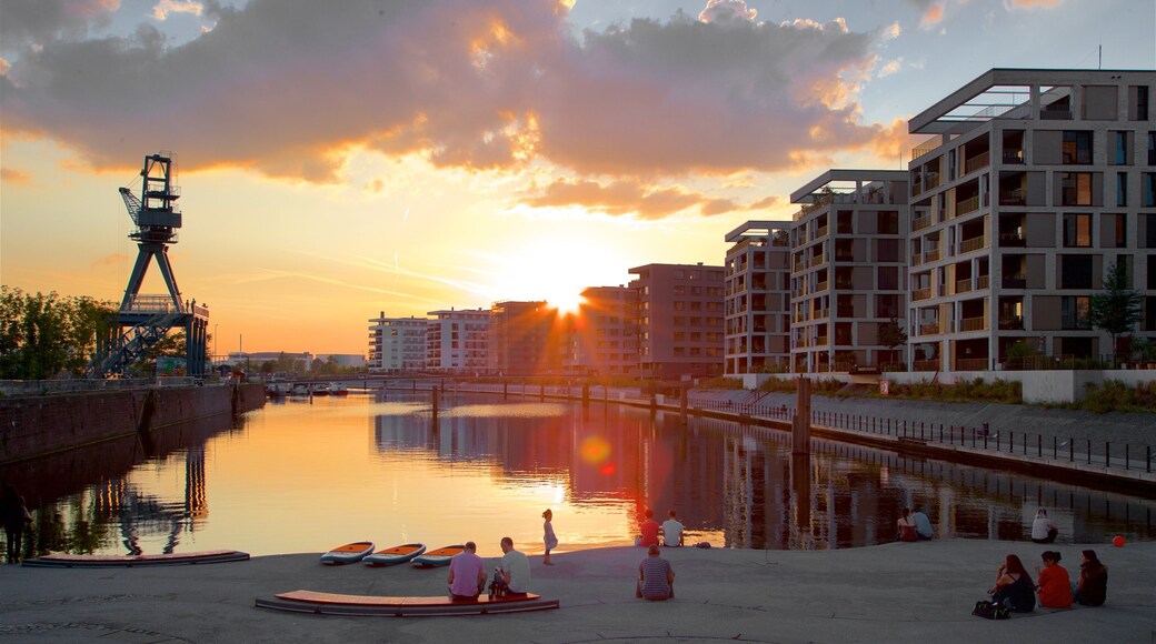 Offenbach am Main featuring a bay or harbour and a sunset as well as a small group of people
