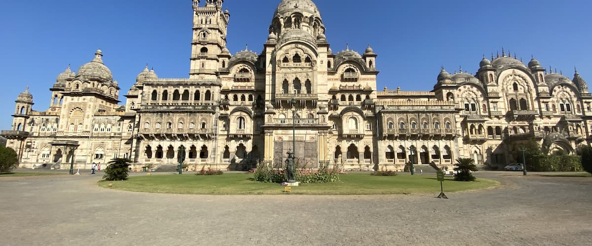 A grand, ornate building with multiple domes and towers, surrounded by a spacious courtyard.