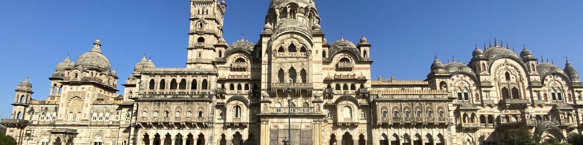 A grand, ornate building with multiple domes and towers, surrounded by a spacious courtyard.