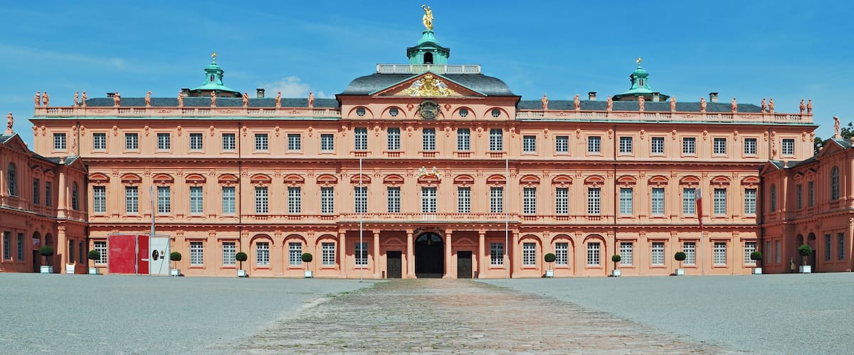 Un edificio grande y ornamentado con una cúpula central y estatuas en el techo.