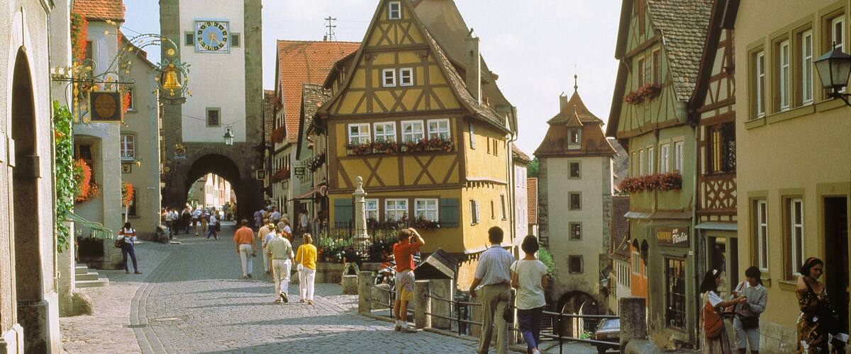 Rothenburg ob der Tauber featuring heritage architecture and street scenes as well as a large group of people